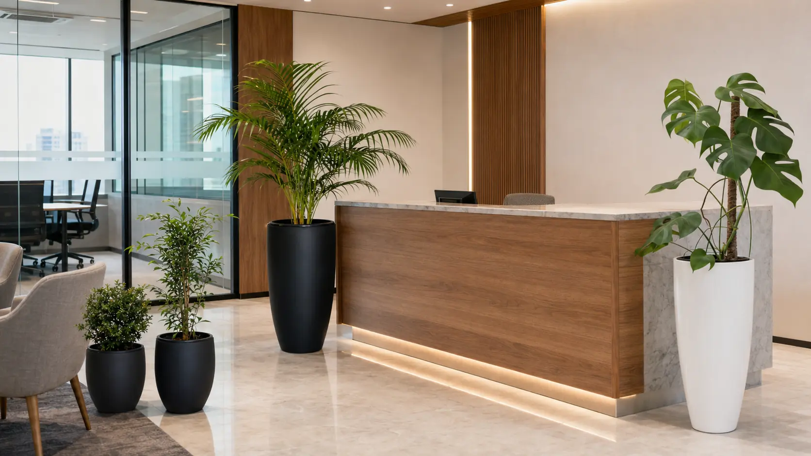 Areca Palm, Monstera and other PlantMe floor plants arranged around an office reception